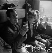 1964, Warszawa, Polska.
Dworzec Gdański, n/z pasażerowie (m.in. żołnierze na przepustce) w przedziale pociągu.
Fot. Marek Zürn, zbiory Fundacji Ośrodka KARTA