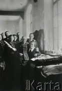 1940, Targu- Jiu, Rumunia.
Polscy wojskowi w obozie internowania; na zdjęciu kilku uśmiechniętych mężczyzn w mundurach i trzy kobiety.
Fot. NN, zbiory Ośrodka KARTA, udostępniła Barbara Tobijasiewicz.