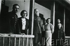 1940, Targu- Jiu, Rumunia.
Polscy oficerowie w obozie internowania, mężczyźni w mundurach i dwie kobiety stoją na ganku domu.
Fot. NN, zbiory Ośrodka KARTA, udostępniła Barbara Tobijasiewicz.