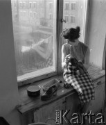 1950-1960, Nowa Huta, Kraków, Polska.
Młoda kobieta czyszcząca buty na parapecie jednego z okien hotelu robotniczego.
Fot. Irena Jarosińska, zbiory Ośrodka KARTA