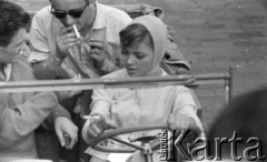 1959, Warszawa, Polska.
Aktorzy Barbara Kwiatkowska i Bronisław Pawlik (na pierwszym planie) oraz asystent reżysera Henryk Kluba (na tylnym siedzeniu) na planie zdjęciowym filmu 