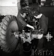 lata 50-te, Puck, Polska
Brygadier pomaga pracownikowi Produkcyjnego Ośrodka Maszynowego w naprawie traktora.
Fot. Irena Jarosińska, zbiory Ośrodka KARTA