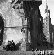 lata 50-te, Kraków, Polska
Rynek Starego Miasta - mężcyzźni siedzą pod Sukiennicami, w głębi widać Kościół Mariacki.
Fot. Irena Jarosińska, zbiory Ośrodka KARTA