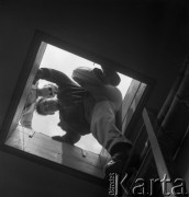 Lata 60. lub 70., Warszawa, Polska.
Mężczyźni schodzą z dachu.
Fot. Irena Jarosińska, zbiory Ośrodka KARTA