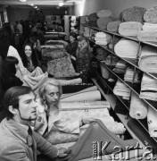 1968-1972, Kraków lub Rzeszów, Polska.
Sklep Banku PeKaO. Klienci oglądają tkaniny. 
Fot. Irena Jarosińska, zbiory Ośrodka KARTA