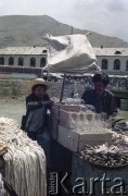 1992, Kabul, prowincja Kabul, Afganistan.
Targ Mandawi (Mandai) przy rzece Kabul. Na zdjęciu sprzedawcy przy stoisku ze szklanymi kloszami i nożami.
Fot. Irena Jarosińska, zbiory Ośrodka KARTA