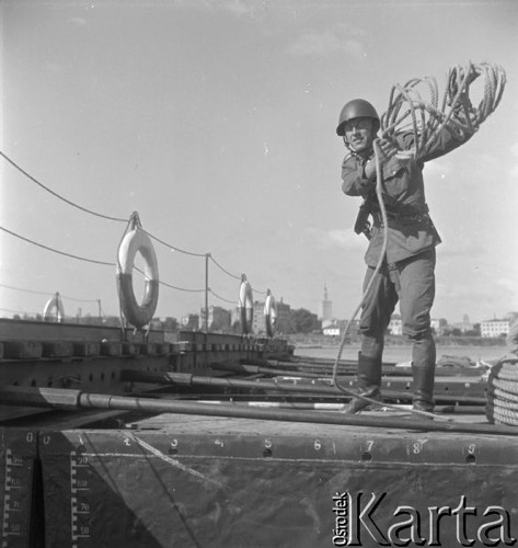 Wrzesień 1958, Warszawa, Polska.
Wojska saperskie ćwiczą przeprawę przez Wisłę - żołnierz rzucający linę.
Fot. Romuald Broniarek, zbiory Ośrodka KARTA