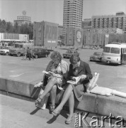 Maj 1976, Warszawa, Polska.
Kiermasz Książki przed Pałacem Kultury i Nauki, dwie kobiety przeglądające książki, w tle hasło: 
