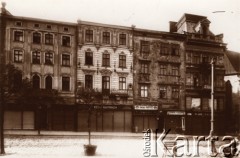 Przed 1914, Lwów, Austro-Węgry.
 Południowa pierzeja Rynku, w głębi fragment Katedry Łacińskiej, szyldy sklepów i zakładów usługowych: 