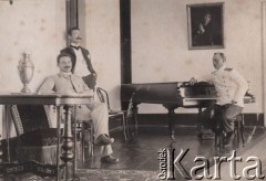Po 1900, Rosja.
Trzej młodzi mężczyźni w salonie, jeden siedzi przy fortepianie.
Fot. NN, zbiory Ośrodka KARTA, kolekcję rodziny Petrulewiczów przekazały Halszka i Wanda Żuromskie
