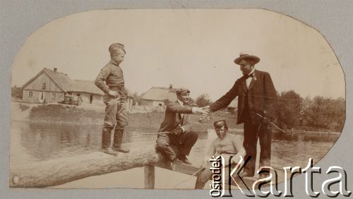 Przed 1914, Rosja.
Mężczyźni i dwaj chłopcy na pomoście. W oddali widoczna jest zabudowa wiejska.
Fot. NN, zbiory Ośrodka KARTA, kolekcję rodziny Petrulewiczów przekazały Halszka i Wanda Żuromskie