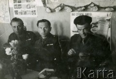 1943-1945, brak miejsca.
Trzej żołnierze armii Andersa w świetlicy, w środku siedzi Wacław Kurman. W tle gazetka ścienna.
Fot. NN, zbiory Ośrodka KARTA, udostępnił Wacław Kurman
