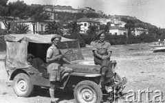 1943-1945, brak miejsca.
Dwaj żołnierze 2 Korpusu obok samochodu, w tle fragment miasta.
Fot. Czesław Dobrecki, zbiory Ośrodka KARTA, Pogotowie Archiwalne [PAF_015], przekazał Krzysztof Dobrecki
