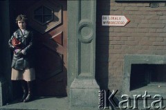 Lata 70., Polska.
Kobieta w bramie. Po prawej stronie znak wskazujący lokal wyborczy.
Fot. Joanna Helander, zbiory Ośrodka KARTA