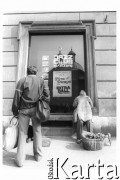 1982, Kraków, Polska.
Mężczyzna i kobieta (zasłania twarz swetrem)  przy oknie jazzowego klubu Pod Jaszczurami. W oknie wisi plakat zapowiedający występy zespołu 