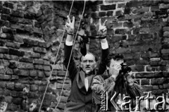 Sierpień 1988, Gdańsk, Polska.
Manifestacja na terenie parafii pw. św. Brygidy w okresie strajków. Uczestnicy demonstracji z rękami uniesionymi w geście zwycięstwa oraz mężczyzna robiący zdjęcie.
Fot. Jan Juchniewicz, zbiory Ośrodka KARTA