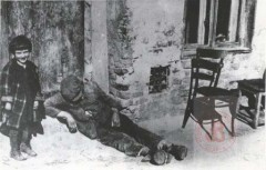 1939-1943, Warszawa. 
Dziecko i mężczyzna leżący pod budynkiem w getcie. 
Fot. NN, Studium Polski Podziemnej w Londynie