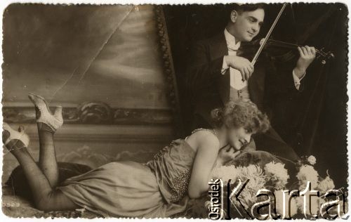 Pocz. XX wieku, Włochy.
Portret zakochanej pary - kobiety w sukni i pantoflach, oraz mężczyzny grającego na skrzypcach. Zdjęcie wykonane w atelier fotograficznym. Tekst na odwrocie w języku polskim: 