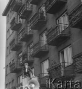 Po 1945, Warszawa, Polska.
Mężczyzna stoi na dachu samochodu przy megafonie. Na balkonach budynku stoją ludzie, którzy oglądają prawdopodobnie pochód uliczny. 
Fot. Jerzy Konrad Maciejewski, zbiory Ośrodka KARTA