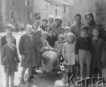 Czerwiec 1940, Saint-Loup-sur-Semouse, Francja.
Kampania francuska. Francuskie dzieci pozują do zdjęcia przy motocyklu należącym do łącznika pułkowego por. Sobczyka (stoi 2. z prawej) z 5 Małopolskiego Pułku Strzelców Pieszych 2. Dywizji Strzelców Pieszych.
Fot. Jerzy Konrad Maciejewski, zbiory Ośrodka KARTA