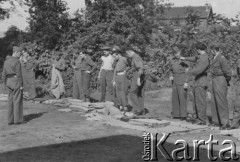 1945-1946, Lys-lez-Lannoy, Francja.
Dowódca prawdopodobnie sprawdza uposażenie należące do polskich żołnierzy z 2. Dywizji Strzelców Pieszych. Przed żołnierzami leżą poskładane koce wojskowe.
Fot. Jerzy Konrad Maciejewski, zbiory Ośrodka KARTA

