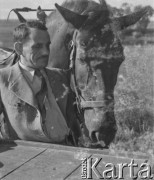 1940-1941, Moospinte, Szwajcaria.
Internowany żołnierz 2. Dywizji Strzelców Pieszych ogniomistrz R. Mańko trzyma za uzdę konia zaprzęgniętego do wozu.
Fot. Jerzy Konrad Maciejewski, zbiory Ośrodka KARTA

