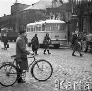 Pażdziernik 1970, Opoczno, Polska
 Kobiety w strojach regionalnych, mężczyzna z rowerem, w tle autobus PKS.
 Fot. Jarosław Tarań, zbiory Ośrodka KARTA [70-117]
   
