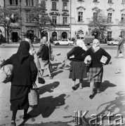 1968, Kraków, Polska.
Przekupki idące z towarem na Rynku Głównym w Krakowie, w tle zabytkowe kamienice.
Fot. Jarosław Tarań, zbiory Ośrodka KARTA