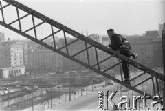 19.03.1963, Warszawa, Polska.
Robotnik wspinający się po ramieniu dźwigu na osiedlu mieszkaniowym 