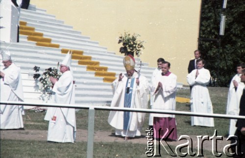 21.06.1983, Wrocław, Polska.
Druga pielgrzymka papieża Jana Pawła II do Polski w dniach 16-23 czerwca 1983 roku. Ojciec Święty w otoczeniu księży przed mszą świętą na hipodromie w Partynicach.
Fot. Edward Grochowicz, zbiory Ośrodka KARTA