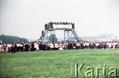 13.06.1987, Łódź, Polska.
Trzecia pielgrzymka papieża Jana Pawła II do Polski w dniach 8-14 czerwca 1987 roku. Wierni podczas mszy świętej sprawowanej przez Ojca Świętego na lotnisku Łódź-Lublinek. Widoczny transparent: 