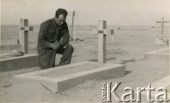 Po 1941, Tobruk, Libia.
Polski żołnierz modli się przy grobie na cmentarzu wojennym.
Fot. NN, udostępnili Zofia i Julian Michalski, zbiory Ośrodka KARTA