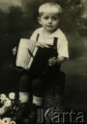 Przed 1939, brak miejsca.
Portret dziecka z akordeonem. Fotografia z rodzinnego archiwum Leopolda Kałakajło.
Fot. NN, zbiory Archiwum Historii Mówionej Ośrodka KARTA i Domu Spotkań z Historią, udostępnił Leopold Kałakajło w ramach projektu 